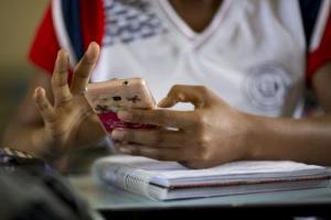 A child looks at his phone in Brazil.